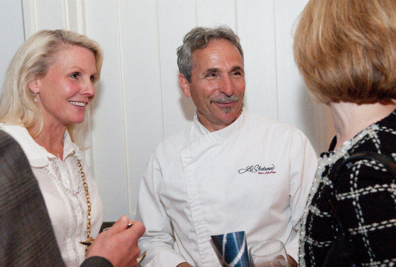 Chef Giorgio standing between two women smiling