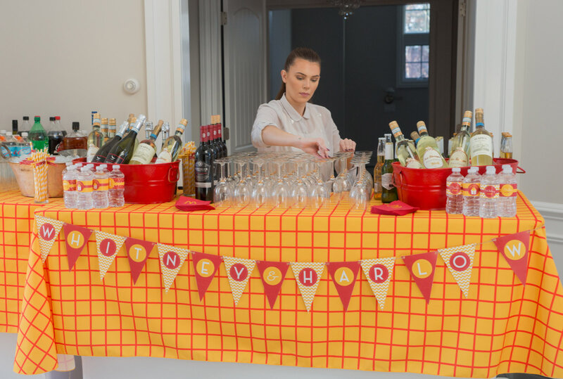 Bar tender at table with orange and red decorations