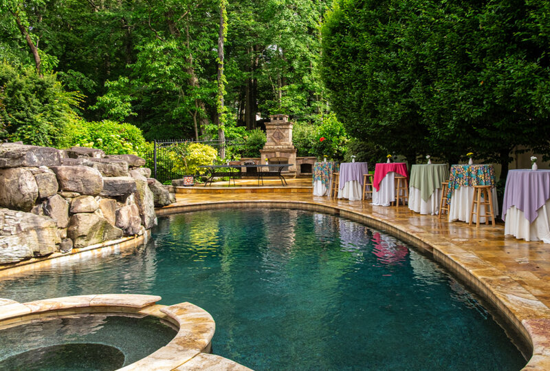 Decorated hightop tables next to swimming pool